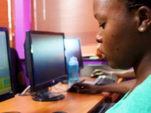 A young woman works on a computer