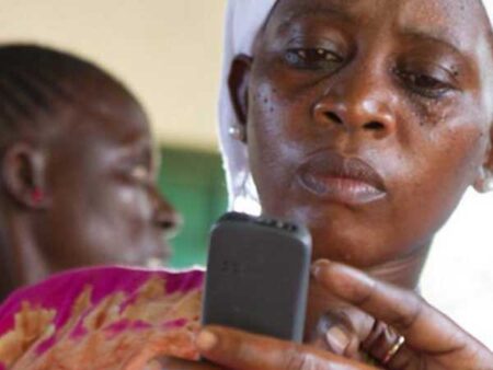 A woman checks information on a mobile device