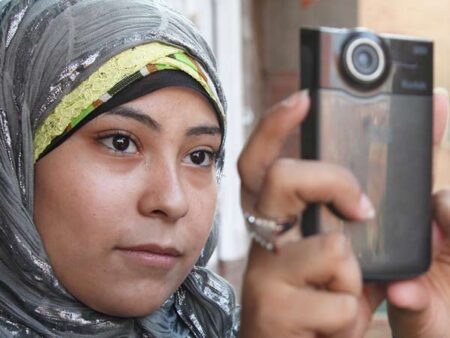 A women records a video using a mobile device