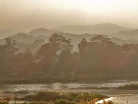 A hilly landscape is bathed in sunlight