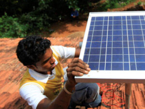 A man works on solar panel equipment