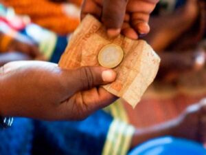 A person holds some cash in their hands