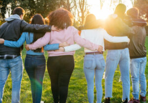 A group of people put their arms around each other