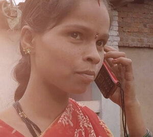 A women holds a phone to her ear